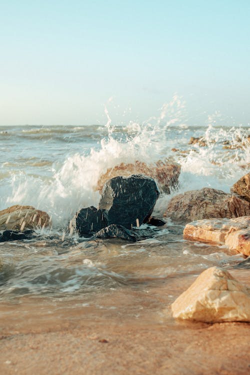 A Beach Waves Crashing on Rocks