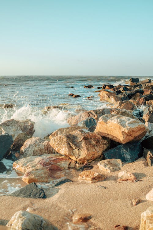 A Beach Waves Crashing on a Rocky Shore