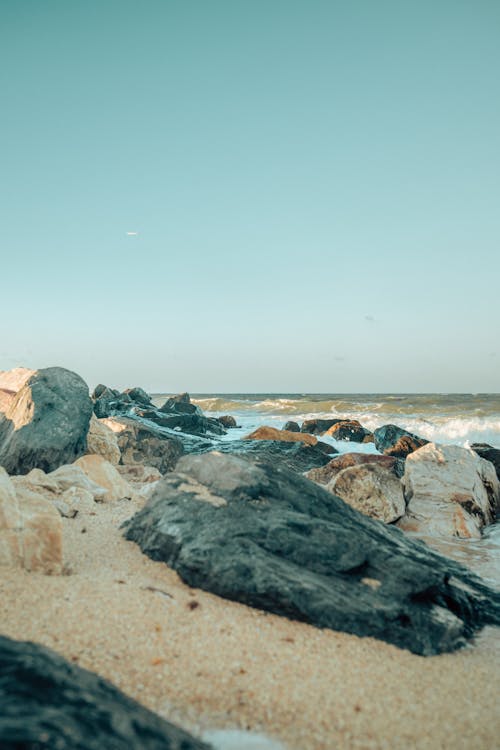 A Rocky Shore on the Beach Under the Blue Sky