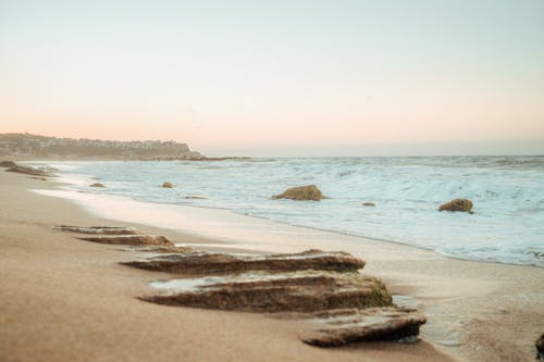 A Beach Waves Crashing on Sand