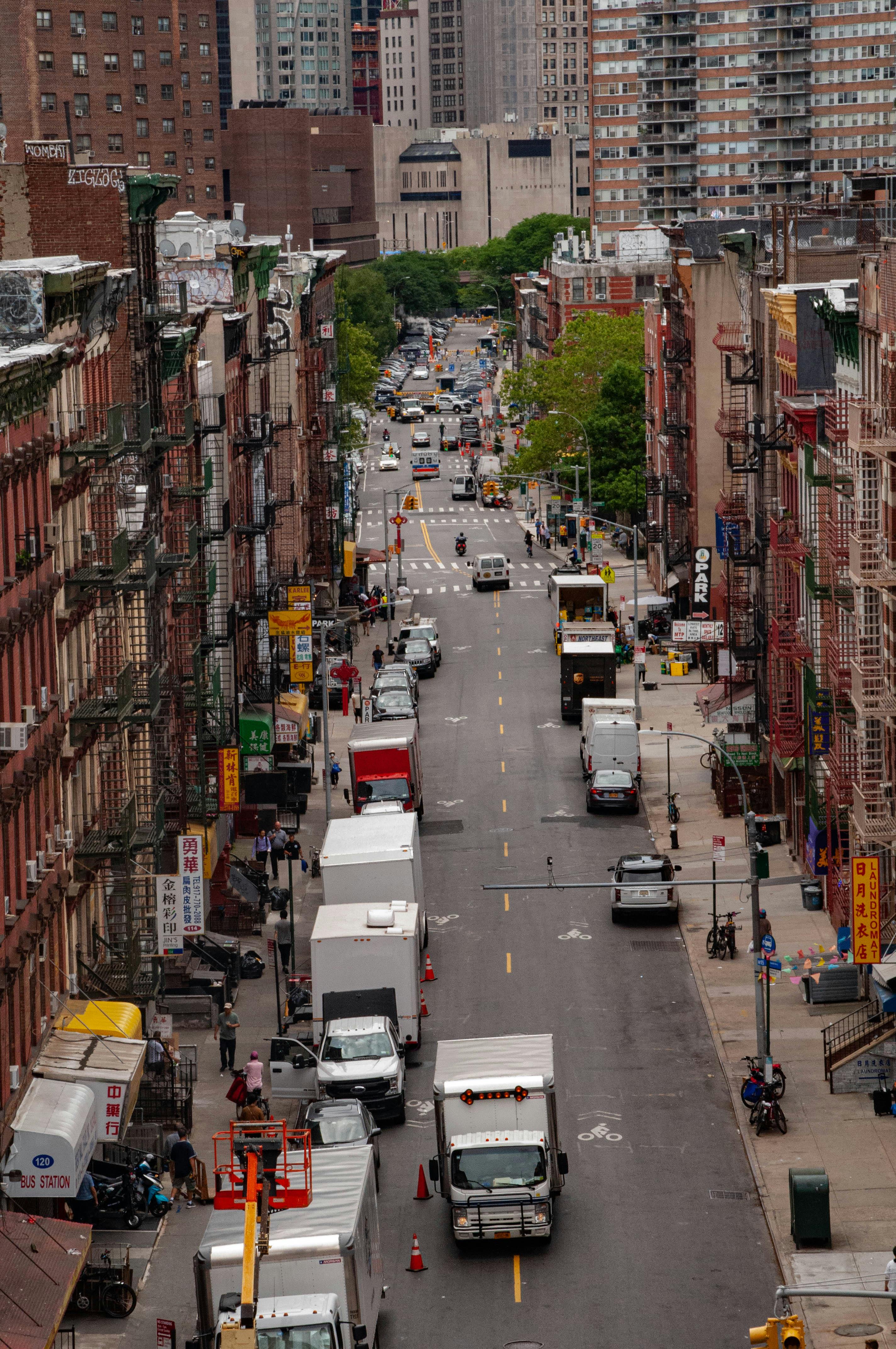 A vibrant aerial view of a busy street in New York City with vehicles and pedestrians.