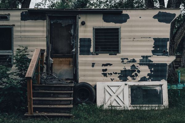 Old weathered mobile home with deferred maintenance