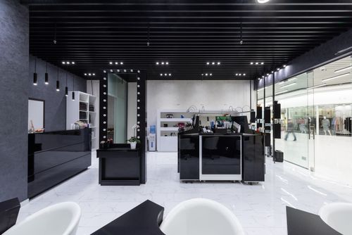 Free Spacious modern salon interior featuring sleek black and white decor with elegant lighting. Stock Photo