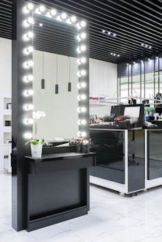 Contemporary makeup station featuring a large illuminated mirror and cosmetics display.