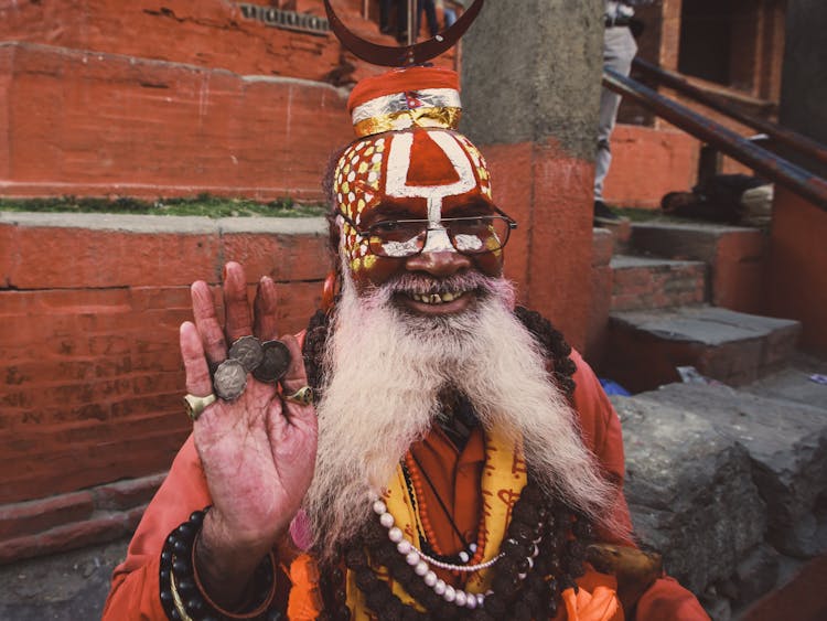 Man With White Beard And Tribal Face Paint Smiling To The Camera