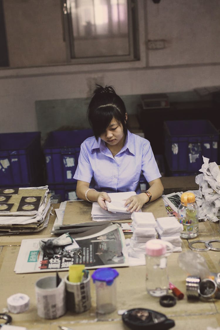 Woman Sitting By Table And Working