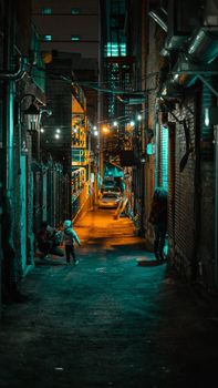 Colorful and moody alleyway scene in Nashville, TN with people enjoying a vibrant night.