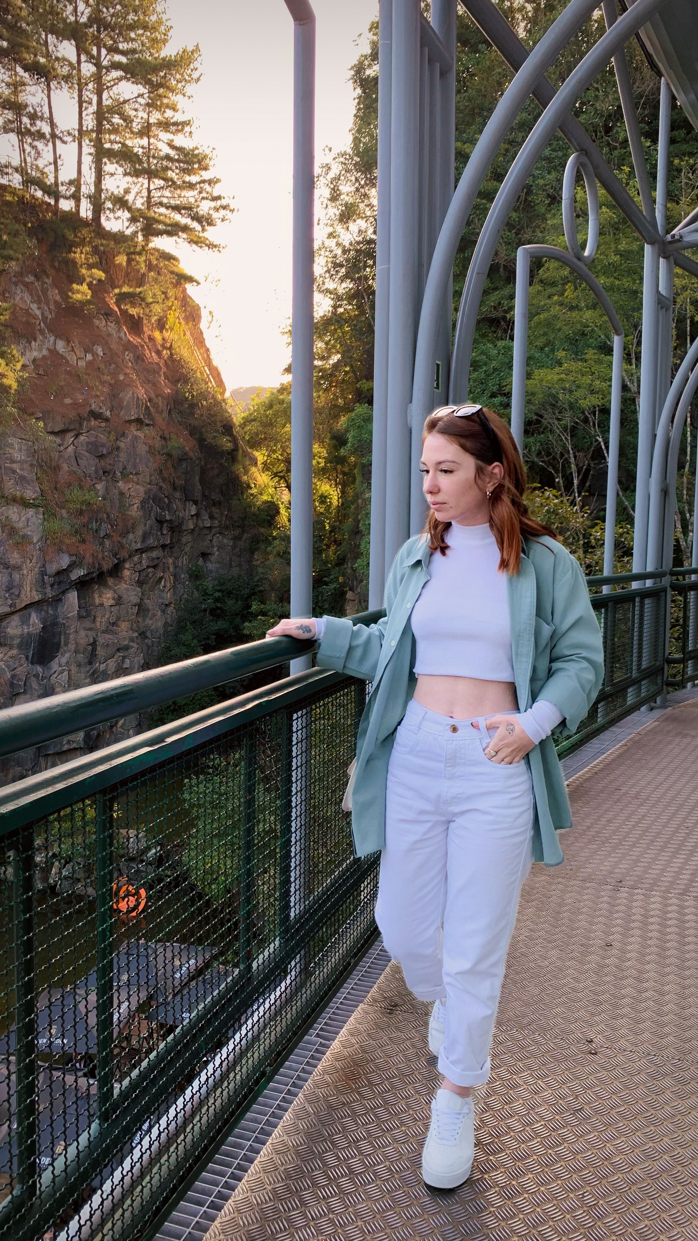 A Woman Walking while Holding on the Railings · Free Stock Photo