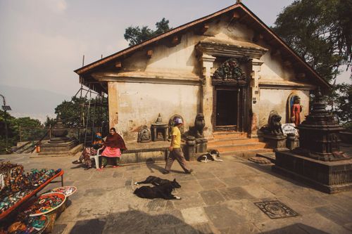Free A serene view of a shrine at Swayambhunath Stupa, showcasing traditional architecture and daily life. Stock Photo