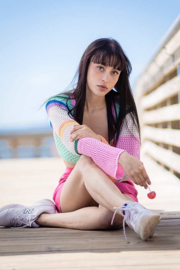 Girl Sitting Wearing Shorts And Openwork Bolero Sitting Cross Legged