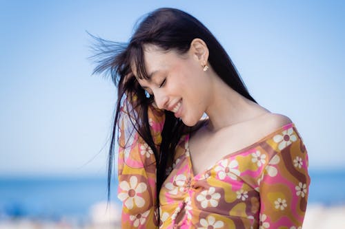 Woman in Floral Long Sleeve Shirt Smiling