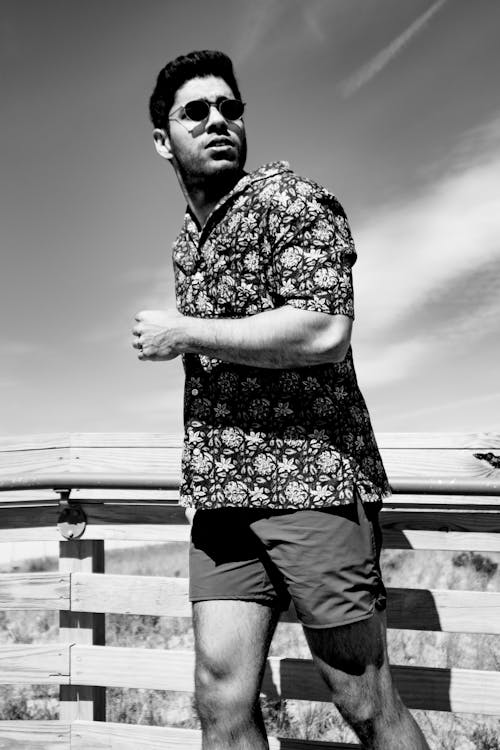 Grayscale Photo of a Man in Shades and a Floral Shirt