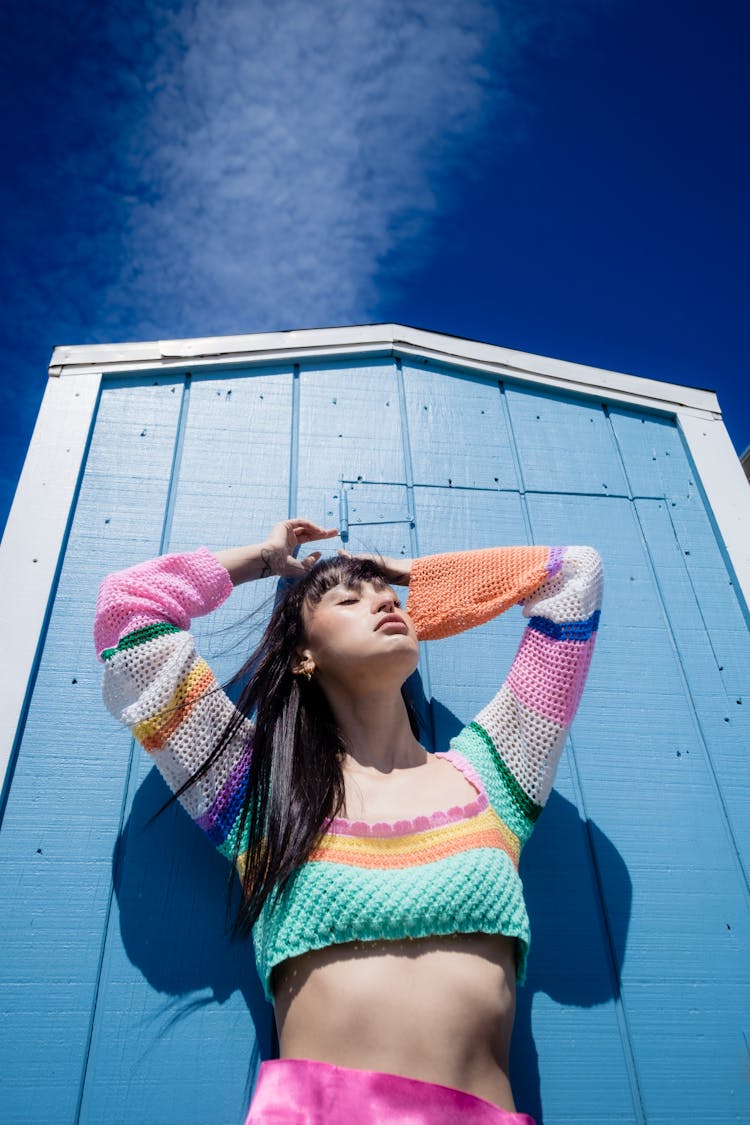 Low Angle Shot Of A Woman In A Colorful Knitted Top