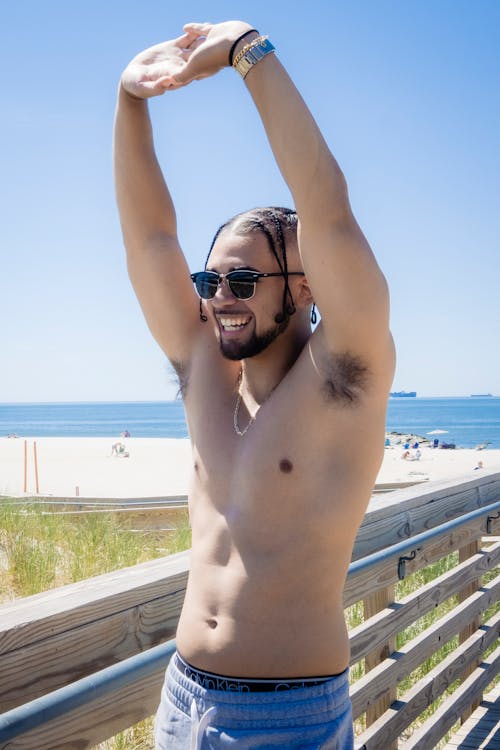 A Topless Man Wearing Black Sunglasses