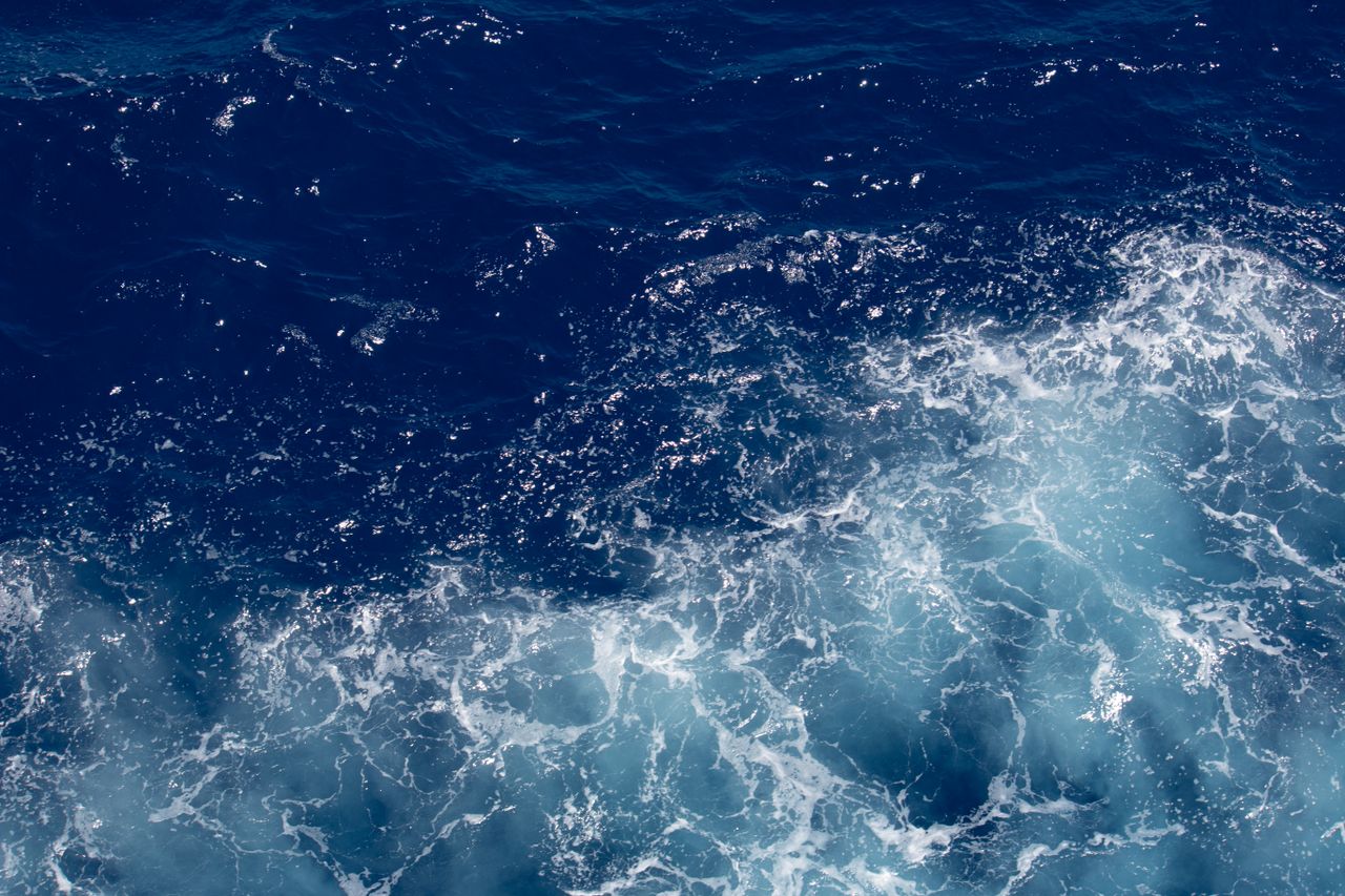a stunning aerial view of vibrant ocean waves and seafoam perfect for