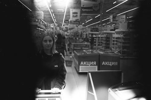 A Woman in Black Jacket Shopping in a Grocery Store