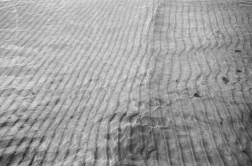 Free Black and white image of rippling sand patterns underwater. Stock Photo