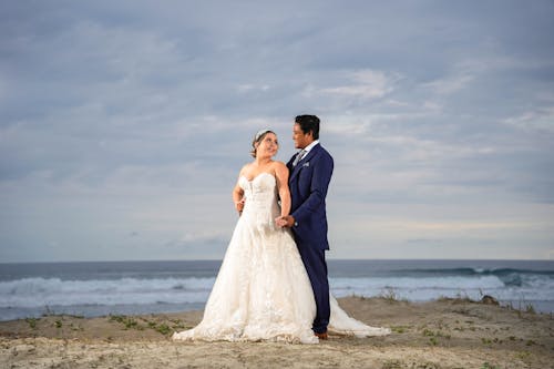 Bride and Groom Standing on Beach