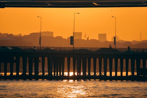 Silhouette of Bridge over Body of Water during Sunset