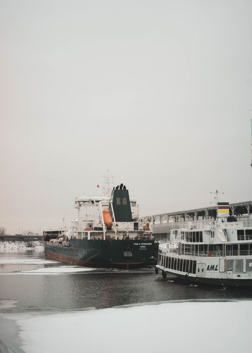 Free Ships docked in a snowy river setting in Ontario, Canada. Stock Photo
