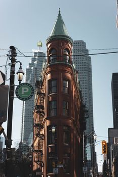 Gooderham Building, a historic architectural landmark in Toronto, stands amid modern skyscrapers.