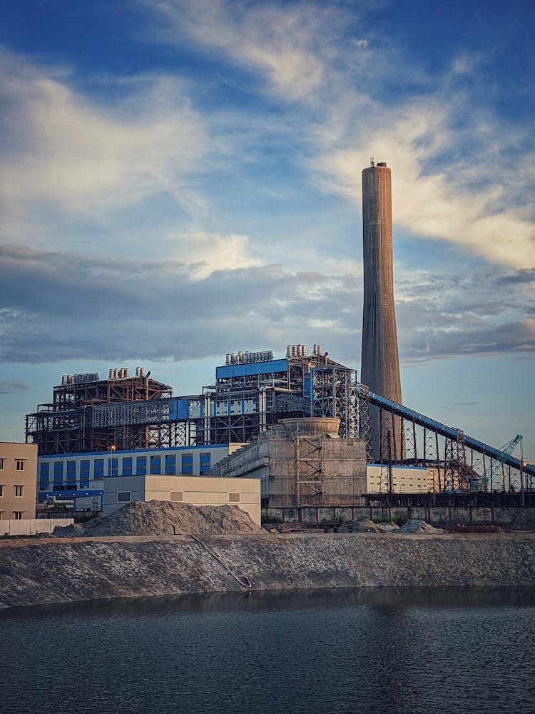 Thermal Power Plant Near A River Under Cloudy Sky