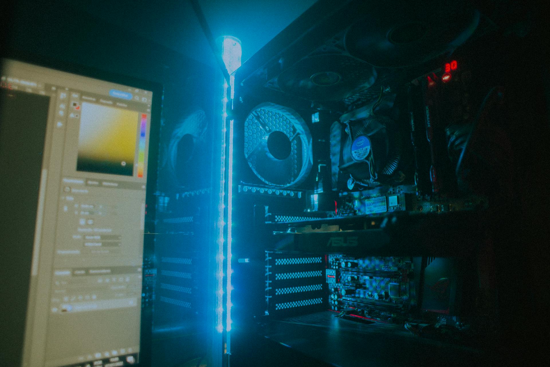 Close-up of an illuminated gaming PC setup showcasing cooling fans and hardware details.