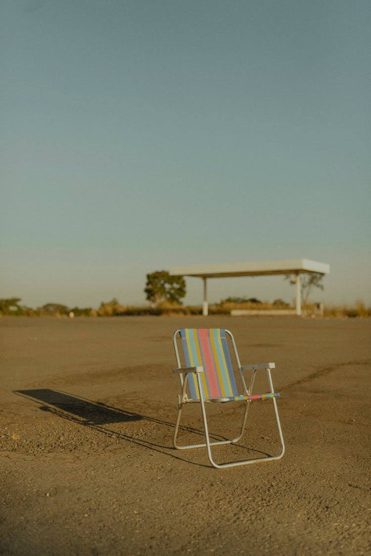 Empty Folding Chair Standing On Beach 