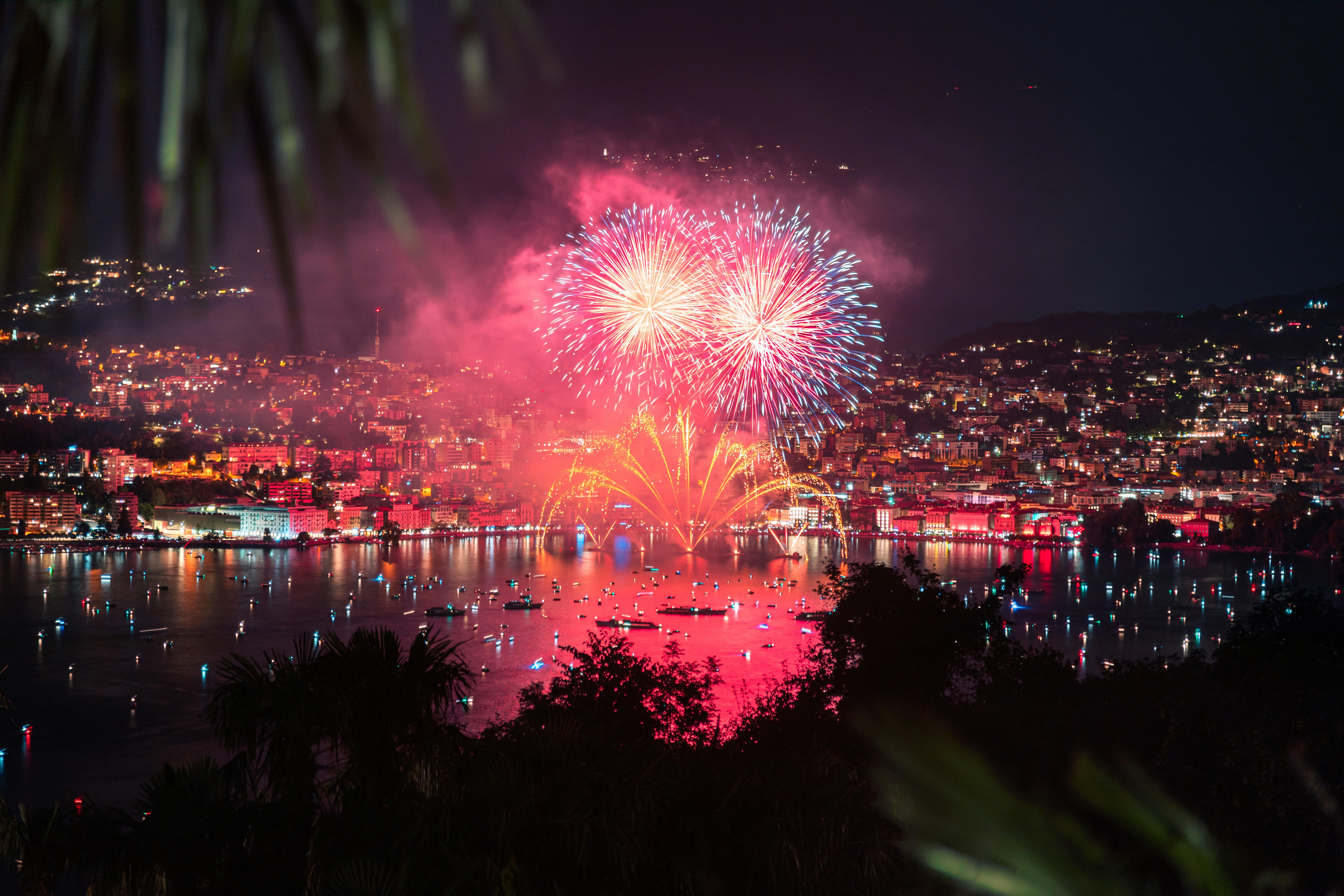 fireworks display over city buildings during night time