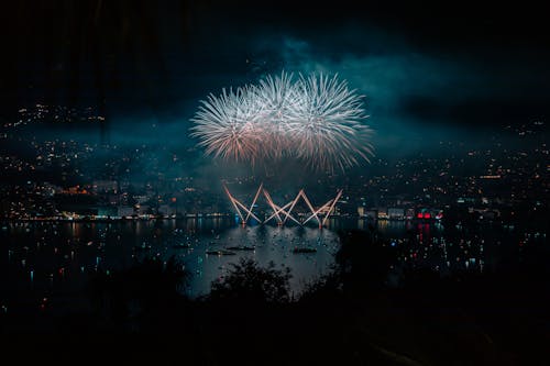 Fireworks Display over Body of Water during Night Time