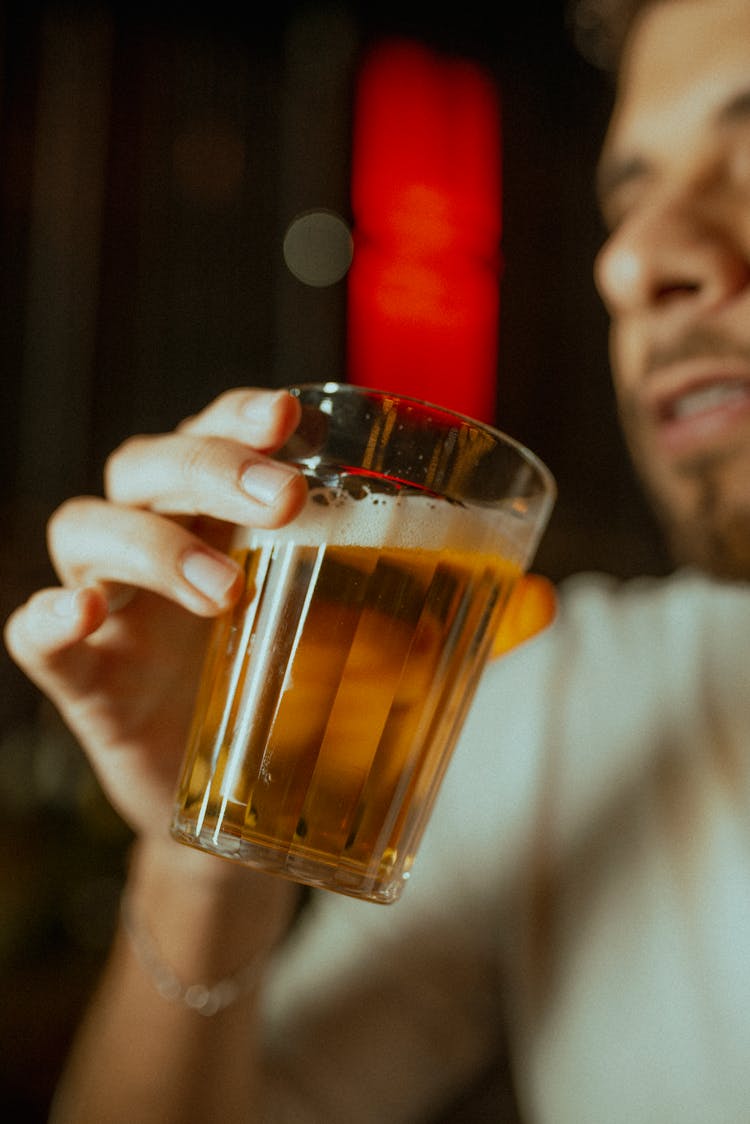 Man Holding Clear Drinking Glass With Beer 