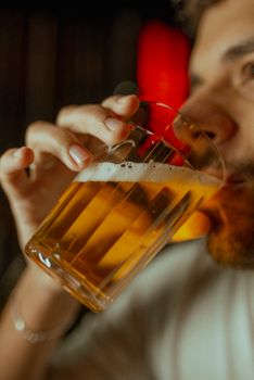 A person enjoys a refreshing beer, perfect for Oktoberfest festivities.