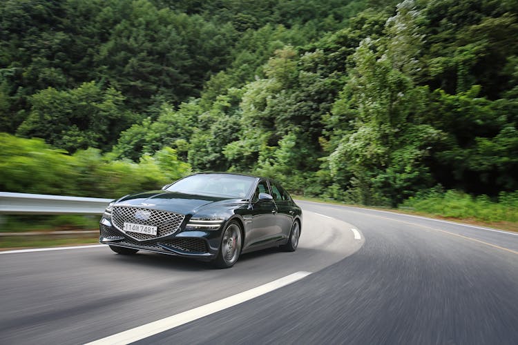 Genesis G80 Running On The Road In The Mountains