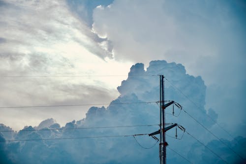 View of White and Blue Clouds Over an Electric Post