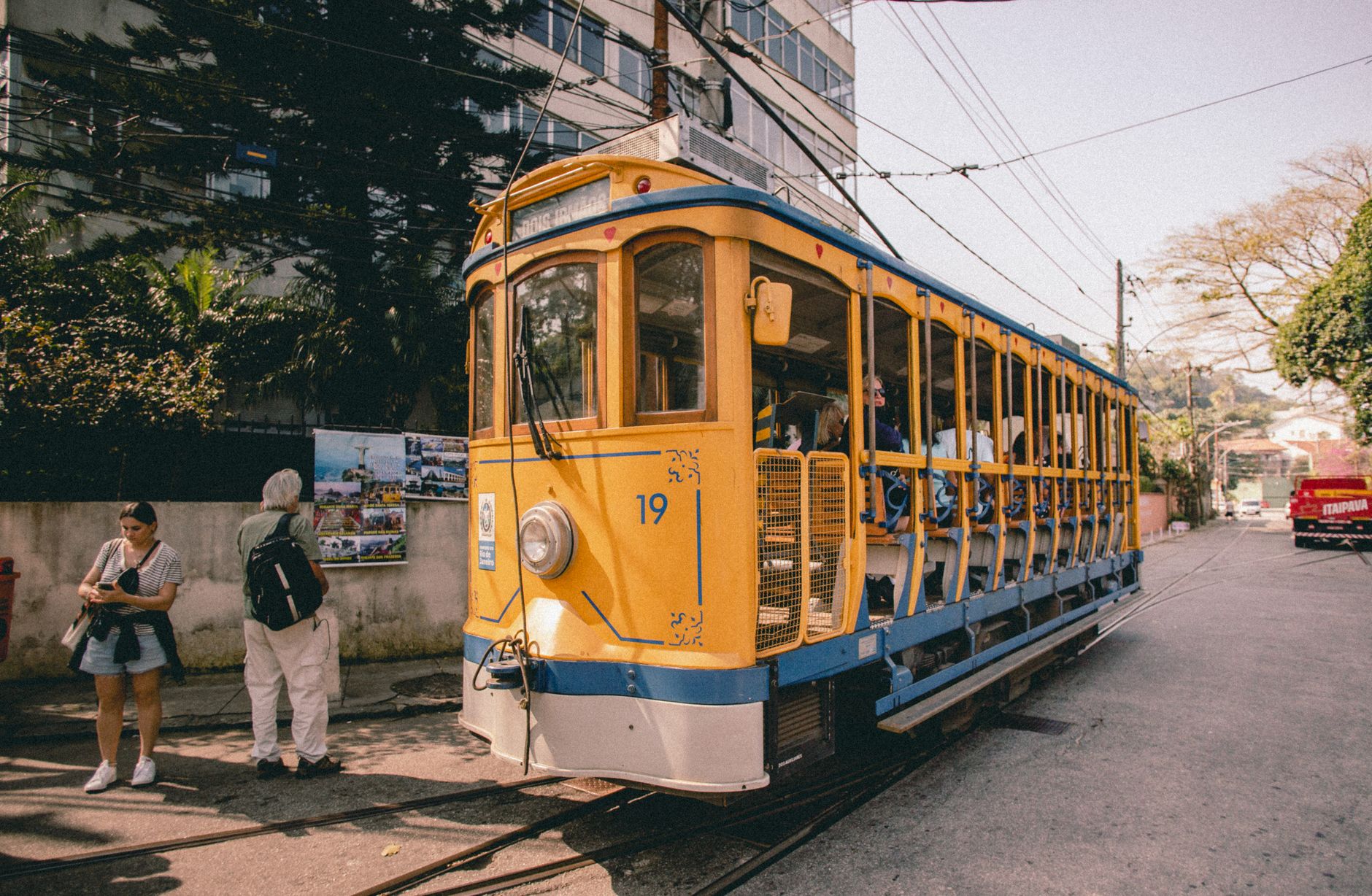 Charming yellow tram on a city street offers urban transportation adventure.
