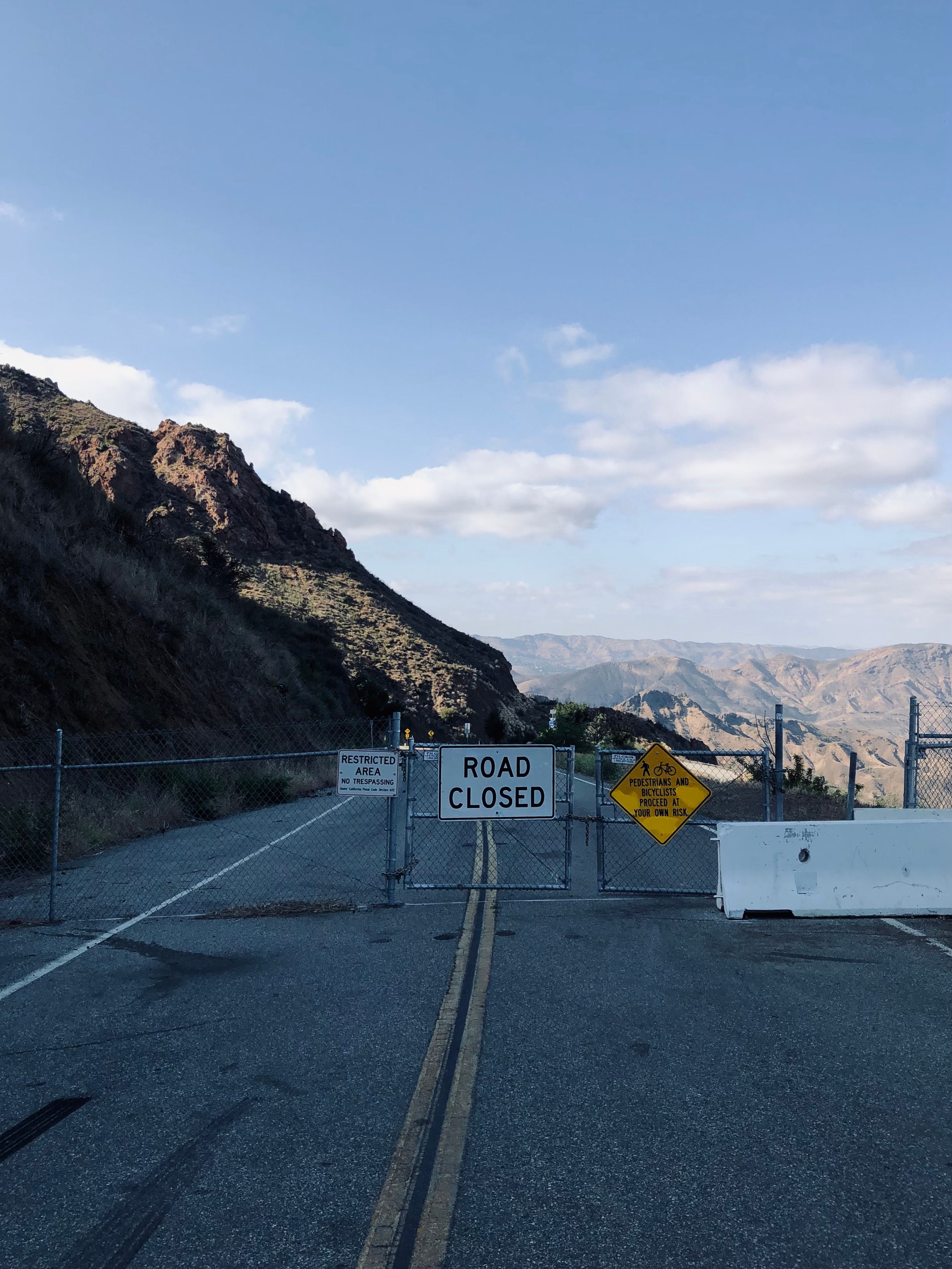 A Sign and Metal Gate on the Road · Free Stock Photo