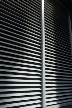 Metal slats create a striking geometric pattern on a modern building facade, showcasing architectural minimalism.