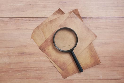 Black Magnifying Glass on Brown Paper