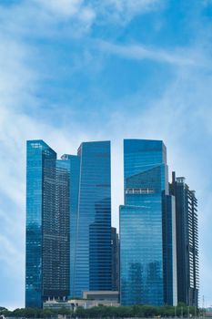 Elegant skyscrapers rise against a clear blue sky in a modern urban landscape.