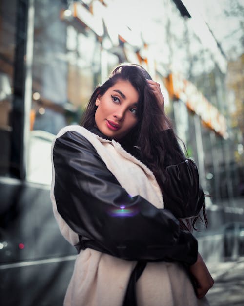 A Woman in Black Leather Jacket with White Vest