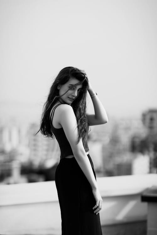 Black and White Photo of a Woman Looking Back