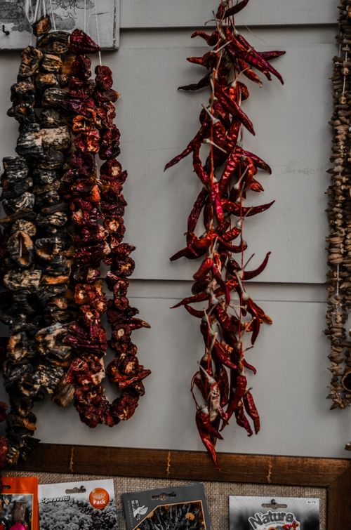 Free Vibrant dried peppers and spices hanging at a traditional Greek market stall. Stock Photo