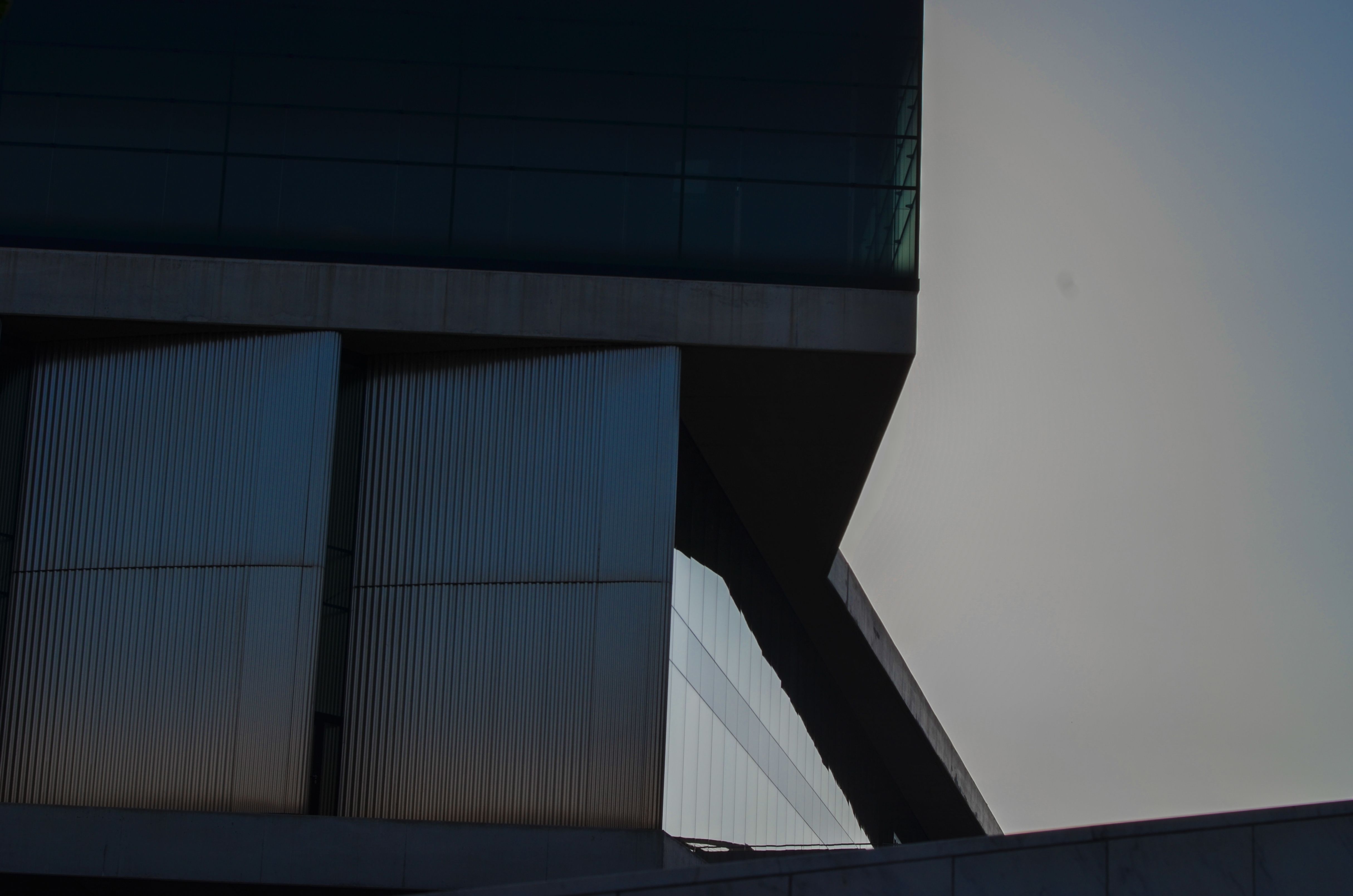 Contemporary building with glass and angles in Athens, Greece at twilight.