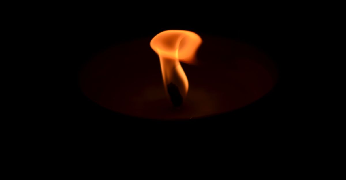 A close-up of a burning candle, echoing the candle close that confirms a genuine break of structure