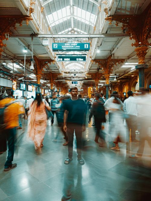 Free Long exposure shot capturing a bustling train station with people moving. Stock Photo