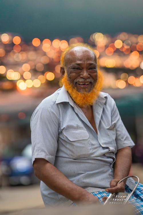 A Bearded Man in Striped Shirt Smiling