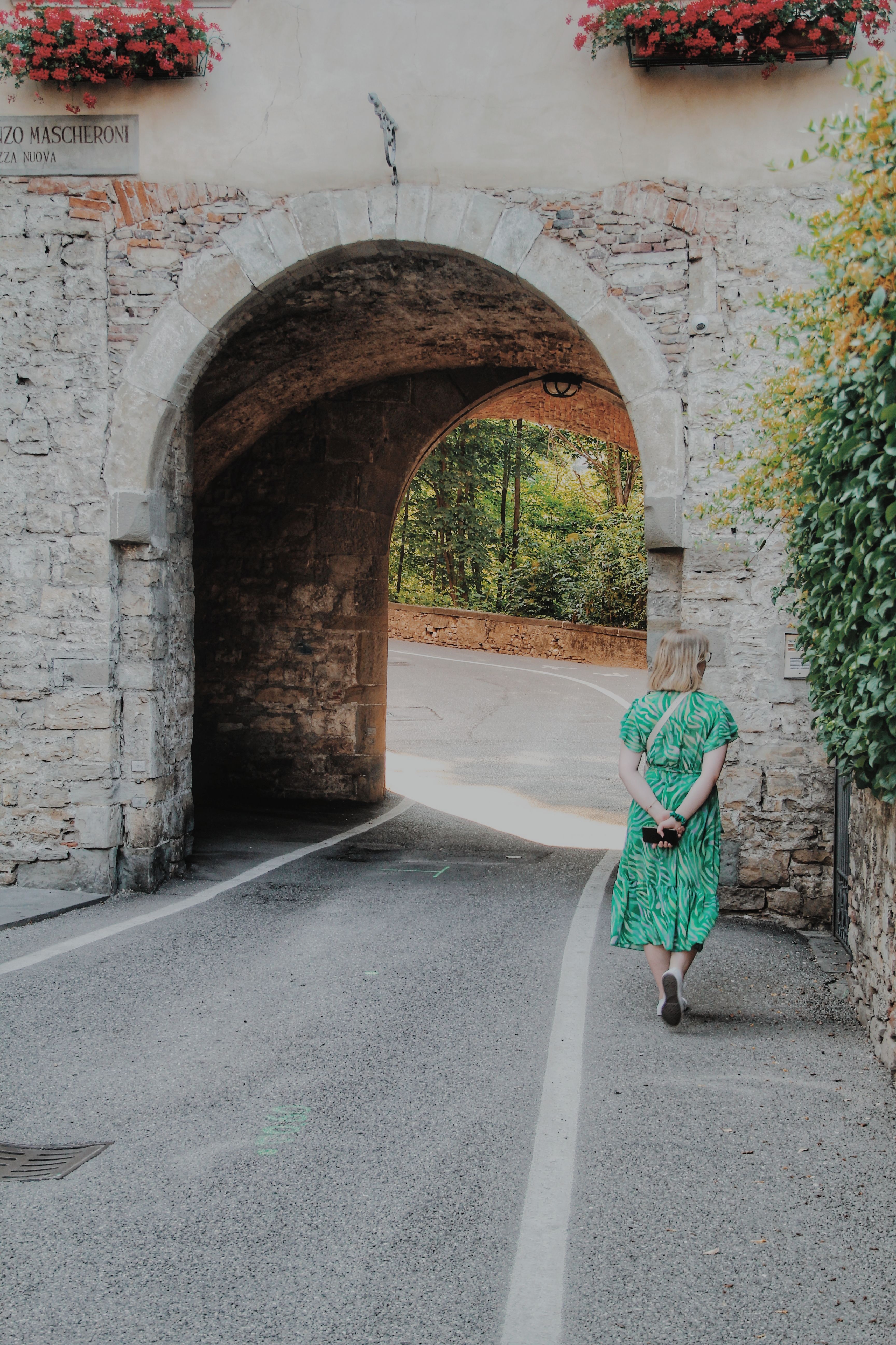 A Woman in Green Dress Walking on the Street · Free Stock Photo