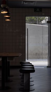 Minimalist design with stools and glass door, perfect for a chic dining experience.