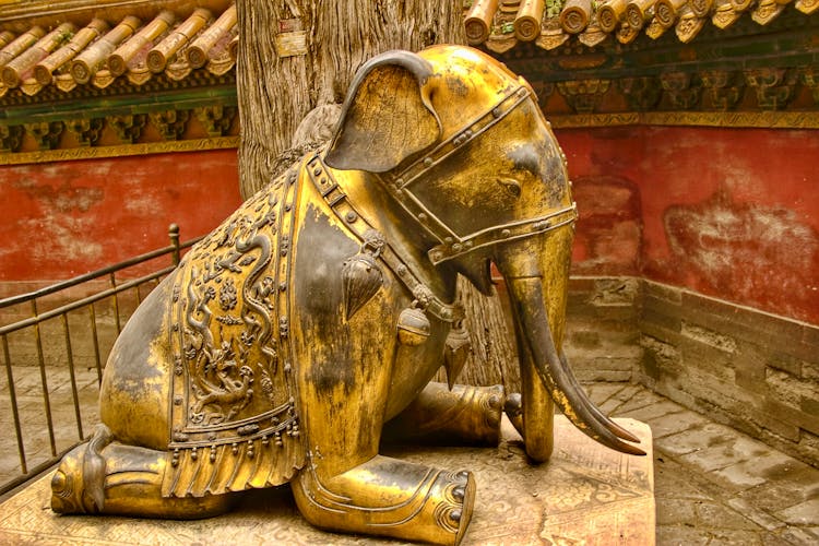 Gold Elephant Sculpture Beside A Tree 