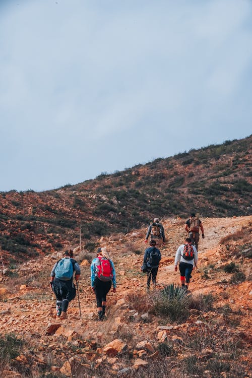 A Group of People Hiking on Mountain